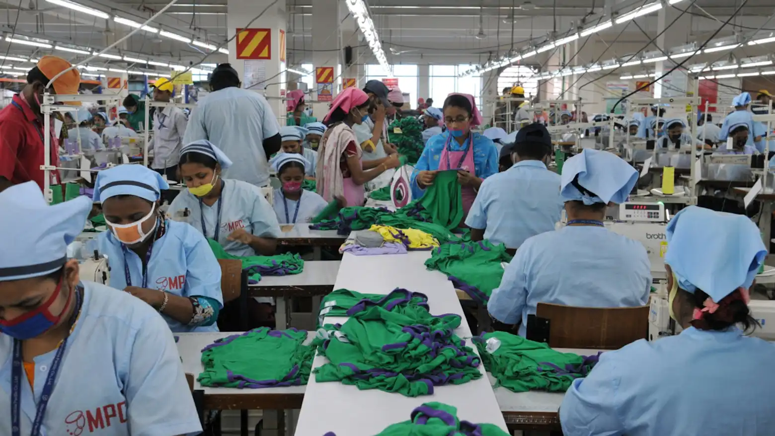 Workers at a garment factory in Bangladesh sew and sort textile products