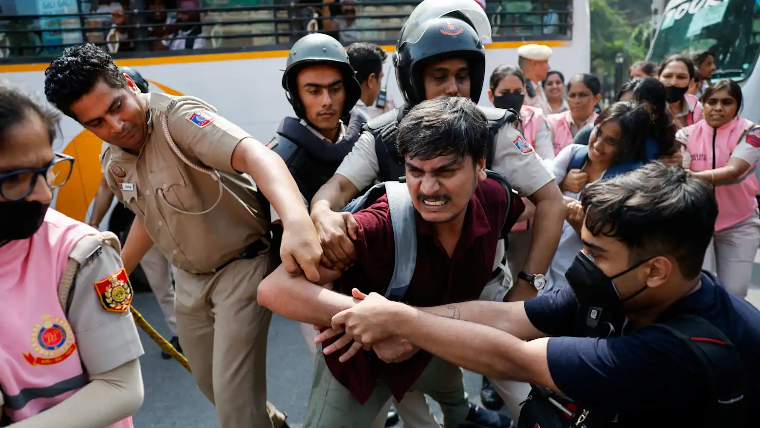 Police officers detain a protester during a demonstration in New Delhi, India
