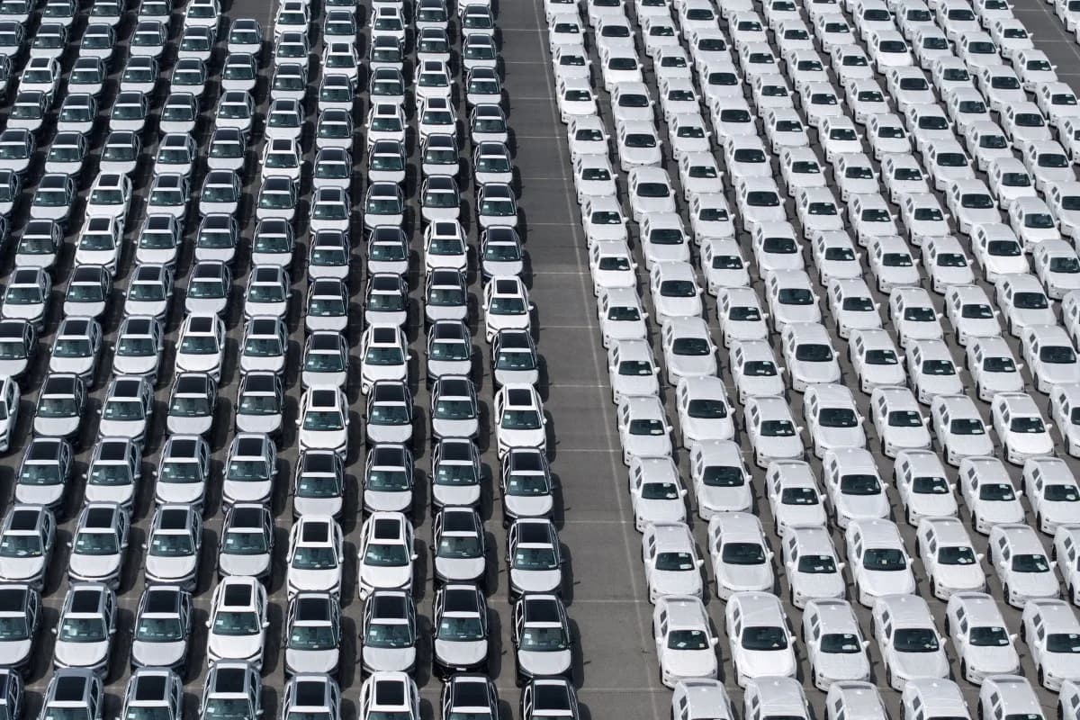 Rows of newly manufactured cars parked in a shipping yard