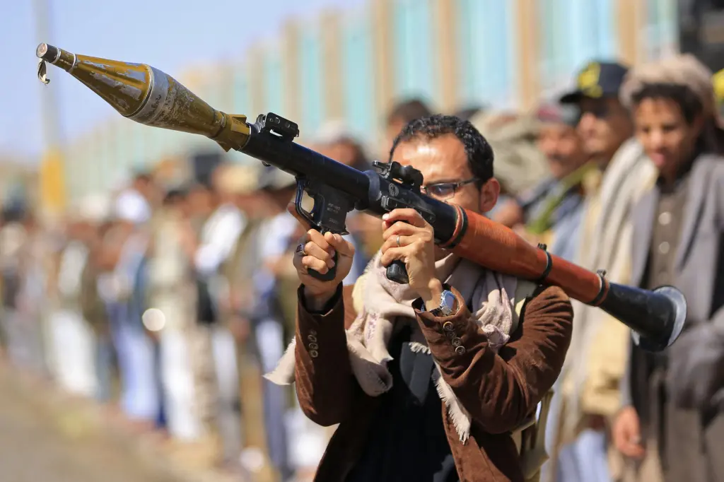 A man holds a rocket-propelled grenade launcher during a gathering in Yemen