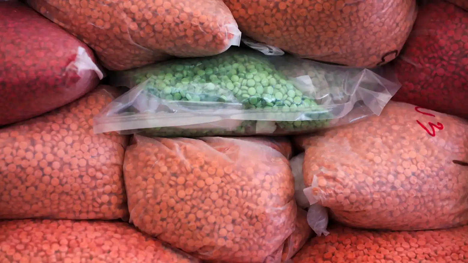 Seized bags of methamphetamine pills stacked together