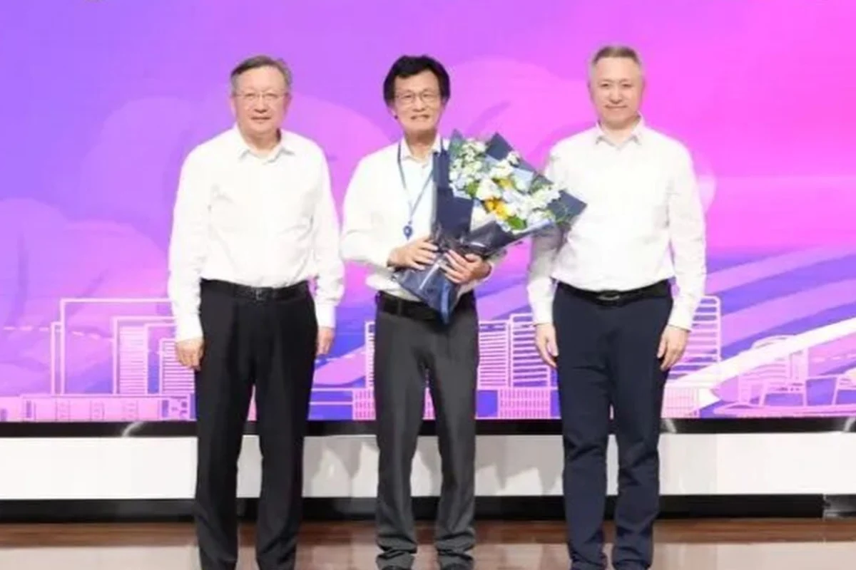 Qian Jiang is presented with flowers at a welcome ceremony