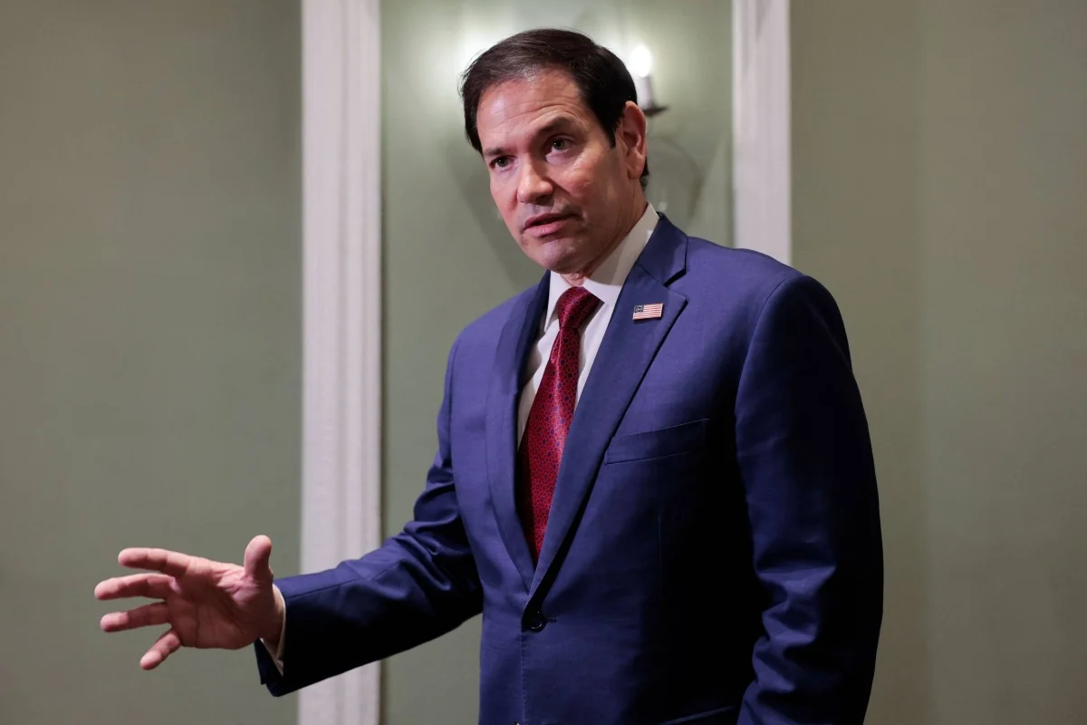 Marco Rubio gestures while speaking to reporters
