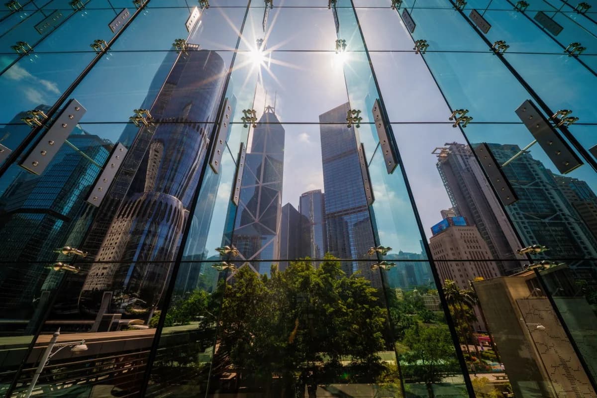 Skyscrapers reflected in a glass office facade in a major business district