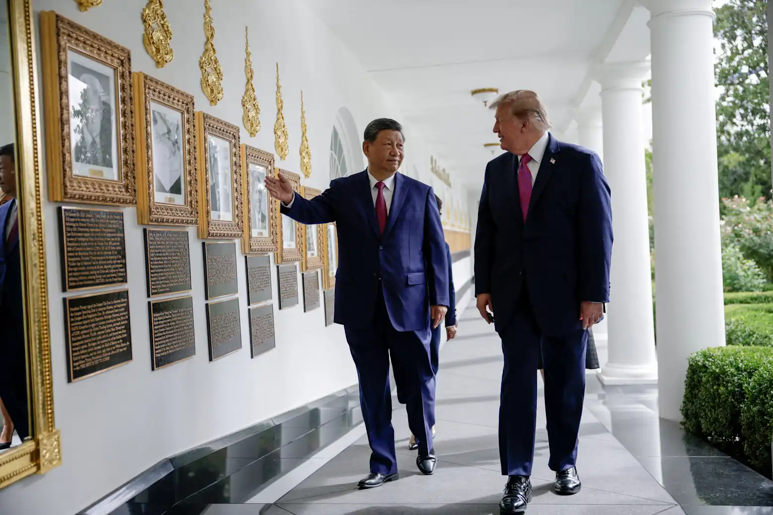 Xi Jinping and Donald Trump walk together along the White House colonnade